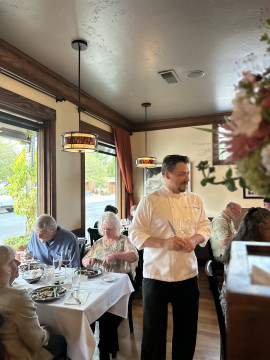 Chef Micah interacting with guests at a dinner