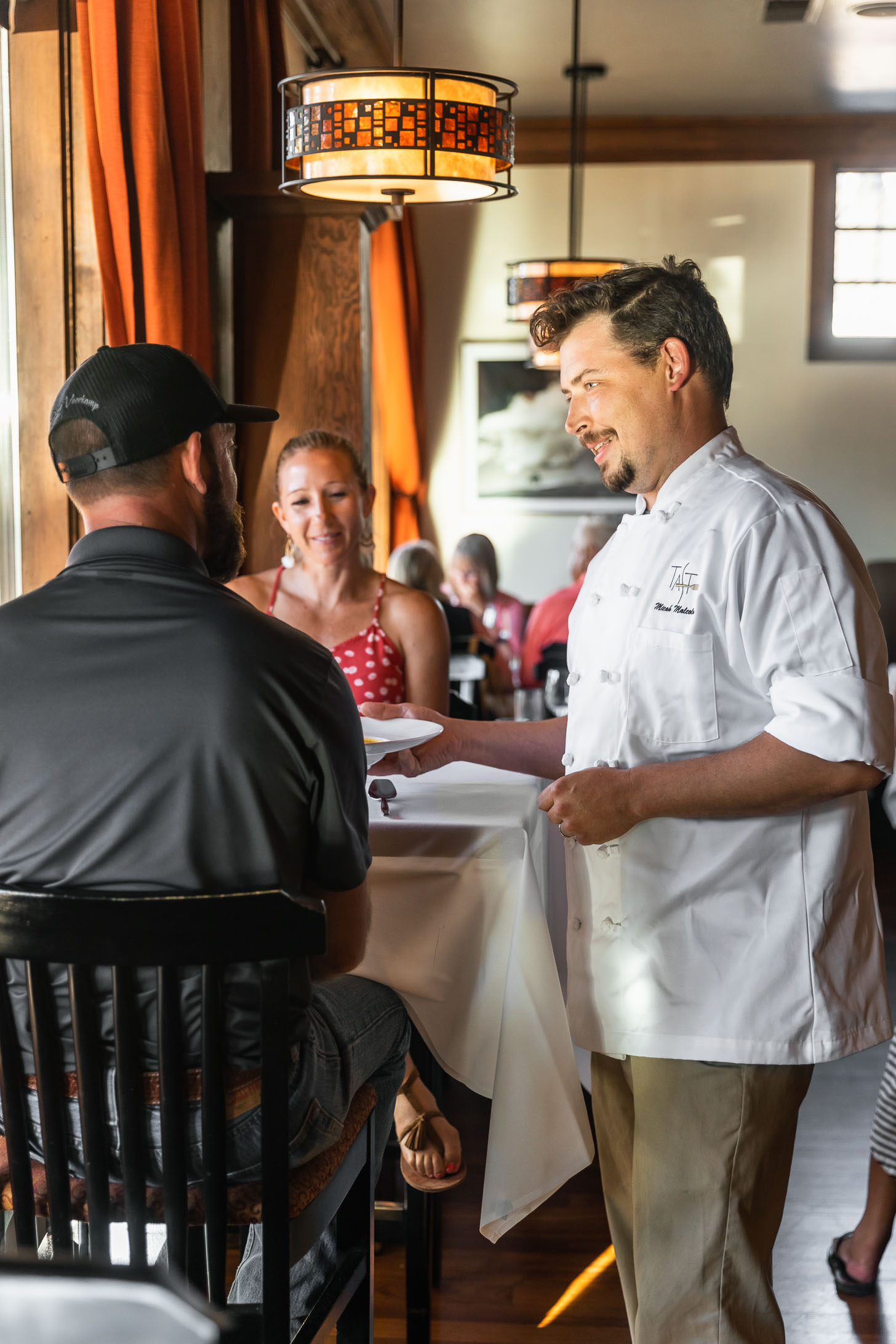 man in chef coast serving food